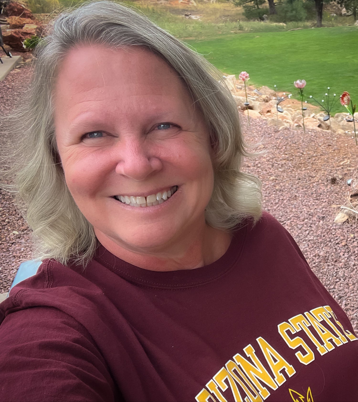 Owner of Every Barcode Need wearing a maroon 'Arizona State Sun Devils' shirt outdoors.